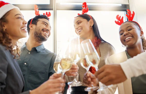 Heres to great things. a group of businesspeople celebrating during a Christmas party at work