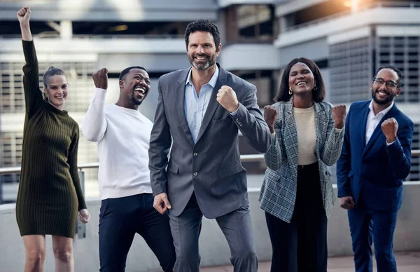 Our morning motivation. a group of businesspeople cheering against a city background