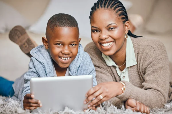 Hes learning so much. a young mother and son using a digital tablet together at home