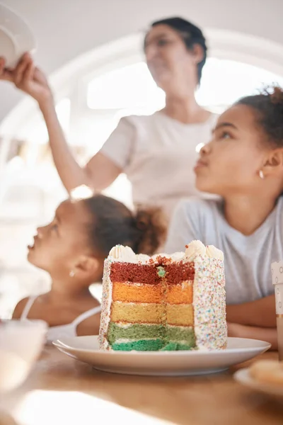 My life is better with every year of living it. a family preparing to eat a cake at a birthday party at home