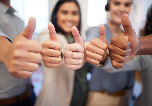 Youll have many rewards to enjoy if you work hard. Closeup shot of a group of unrecognisable businesspeople showing thumbs up in an office