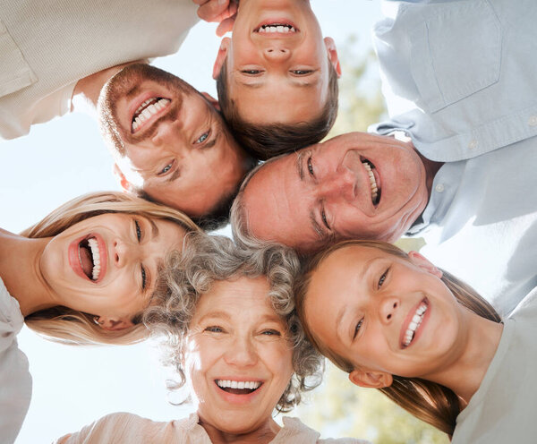 Being a family means you are a part of something very wonderful. a multi-generational family standing together in a huddle