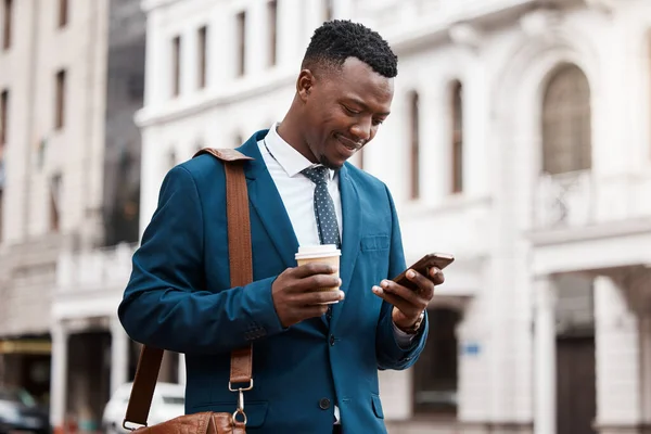 There is no such thing as too much work. a content businessman using his smartphone to send a text while in the city