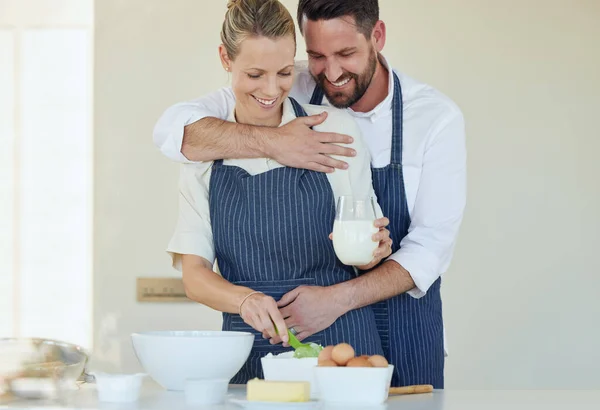 Cooking is our favourite thing to do together. a young couple cooking together at home