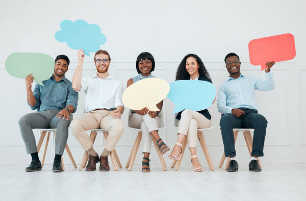 We want your opinion. a group of businesspeople holding speech bubbles while waiting in line at an office