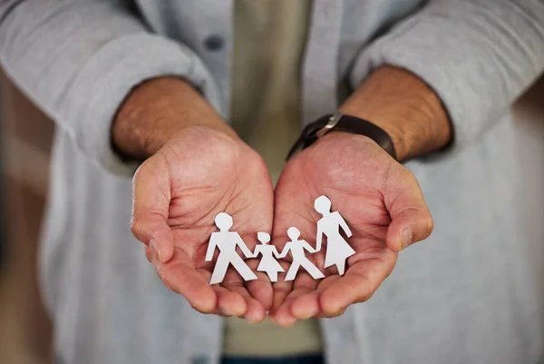 The future is in your hands. a businessman holding a cutout of people