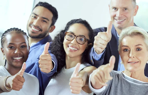 Weve got whatever you need. a group of businesspeople showing a thumbs up at work