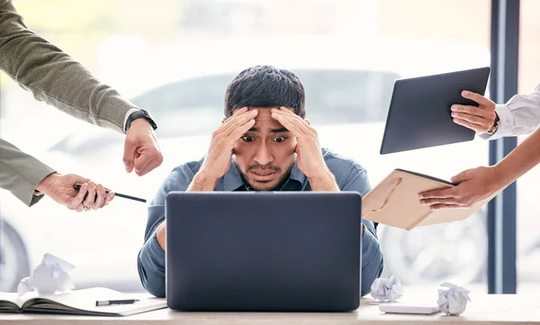 Im going to quit. a handsome young businessman sitting in the office and feeling stressed while his colleagues put pressure on him