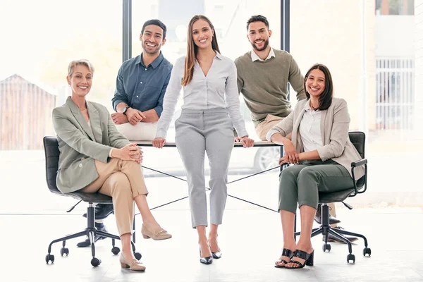 Leave the hard work to us. Full length shot of a diverse group of businesspeople sitting together in the office during the day