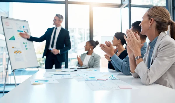 Meeting, presentation and applause with a business man training his team during a boardroom workshop. Leadership, education and strategy with a CEO, manager or leader coaching his employee staff.