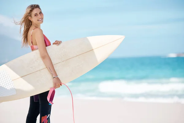 Beach, surfing and woman with surfboard, standing with smile on face in Australia. Surf, ocean waves and girl ready for water sports, enjoying summer holiday. Travel, sea and happy surfer in nature.