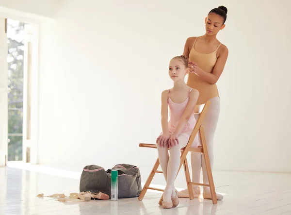 完善是关键 一个芭蕾舞演员帮助一个年轻姑娘在舞蹈室里梳头 — 图库照片