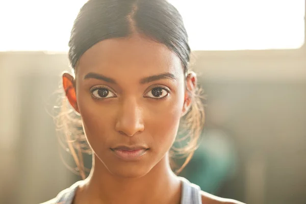 Face your fitness goals dead in the eye. Portrait of a fit young woman working out in a gym