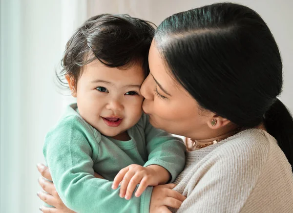 You are loved little one. a beautiful young woman bonding with her baby at home