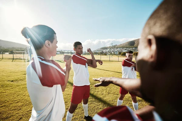 Soccer, team and stretching for fitness, game and wellness on a sport field together outdoor. Football men group with teamwork, support and collaboration during training or workout for sports match.