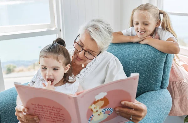 Book, family and children with a grandmother and girl kids reading a story in a home living room together. Retirement, love and learning with an elderly female and sister siblings bonding in a house.