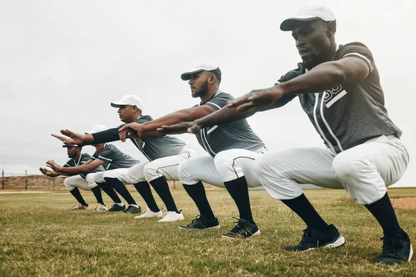 Team, stretching and baseball players for game, exercise and baseball in sportswear on field. Workout, squat and group for match prepare, wellness and fitness being being focus on baseball field.