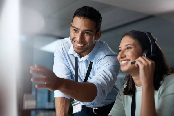 Who knows the brand better than they do. a young man and woman using a computer while working in a call centre