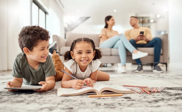 Happy family, learning and kids on a floor, drawing, bonding and relax with parents on sofa in the background. Children, learning and family quality time in a living room with boy and girl having fun.