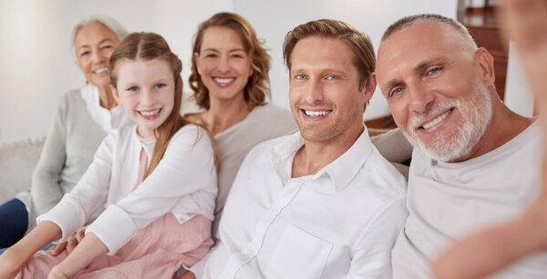 Selfie, happy and big family on the sofa in their living room for happiness, care and relax together in their house. Portrait of grandparents, parents and child with smile for a photo on the couch.