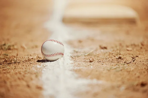 Baseball, chalk line and ball on field before sports game, training and practice. Competition, motivation and sport equipment on baseball field ground. Isolated, close up and copy space for softball.