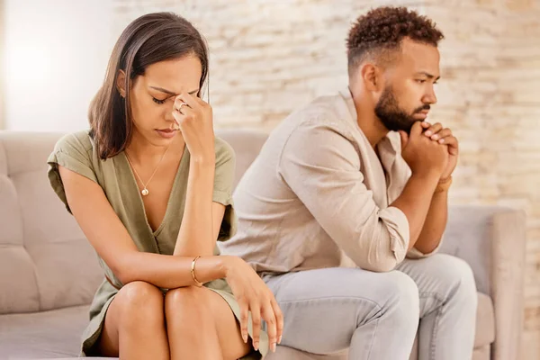 Fight, divorce and depression with couple on sofa for conflict, therapy and mental health or marriage counseling. Sad, anxiety and stress with man and woman in living room for fail, crisis and angry.