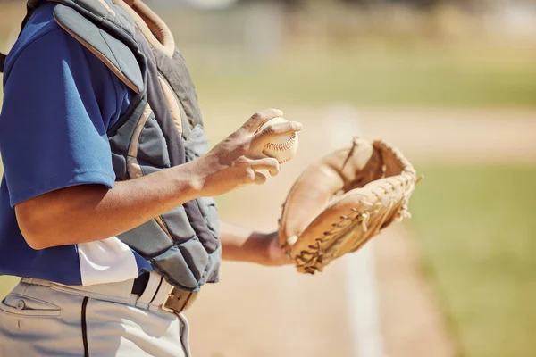 Baseball pitcher, sports and man athlete with ball and glove ready to throw at game or training. Fitness, exercise and professional male softball player practicing to pitch for match on outdoor field.