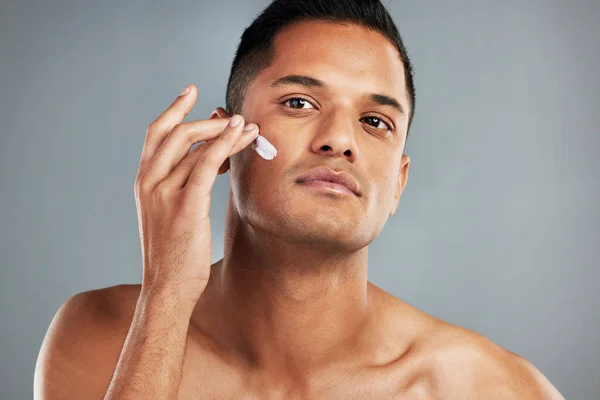 使用护肤产品 乳液和润肤霜的美容 护肤和面部涂满乳霜的男人 在灰色背景演播室为男性提供美容产品的年轻男性的面部 健康和健康皮肤 — 图库照片