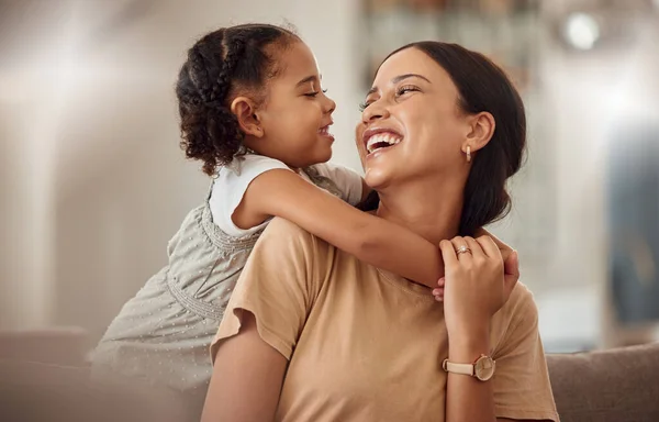 Happy mama with girl child, hug in home and weekend play time lifestyle for mom parent. Funny crazy kid in living room, mother holding toddler with smile and love bonding together on mothers day.