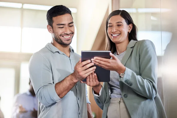 What do you think about this. two coworkers talking while using a digital tablet