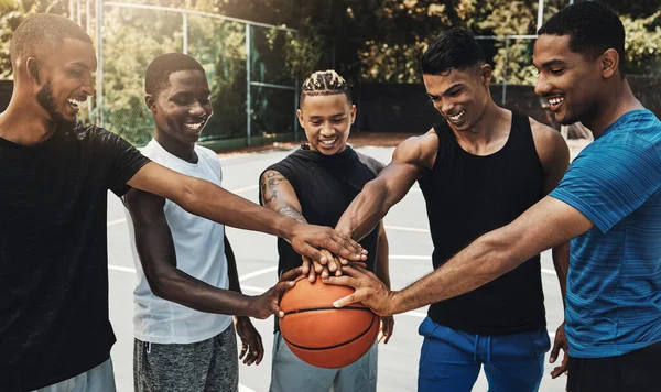 Training, friends and community support by basketball players hand connected in support of sports goal and vision. Fitness, trust and motivation on basketball court by happy, united professional men.