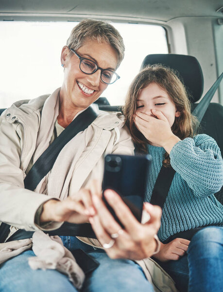 Phone, surprise and mother with child on car journey, travel or road trip for adventure, bond or fun quality time together. Love, shock or transport for kid girl with happy mom streaming online movie.