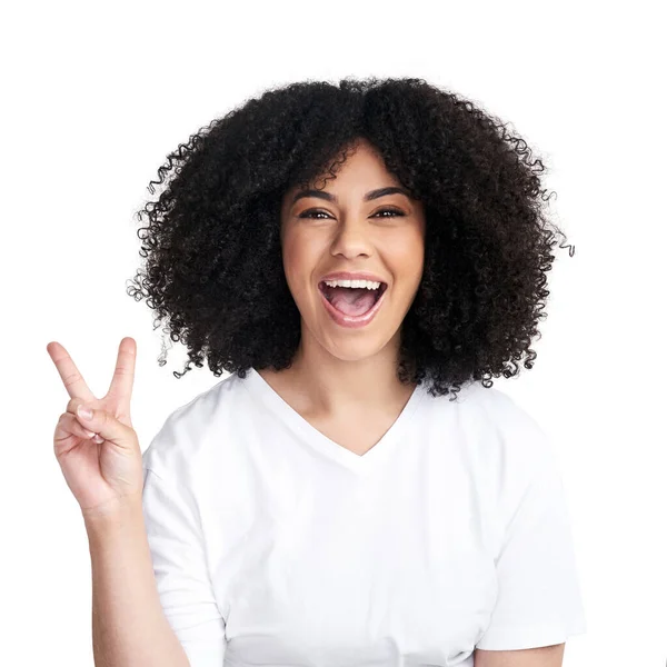 You give love, you get love. Studio shot of an attractive young woman making a peace gesture against a white background