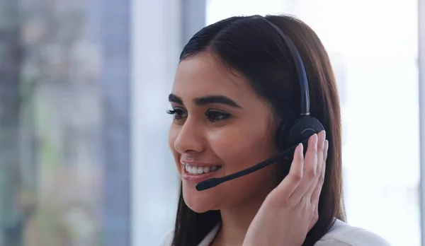 Assisting customers with all their inquiries. a young businesswoman wearing a headset while working in an office