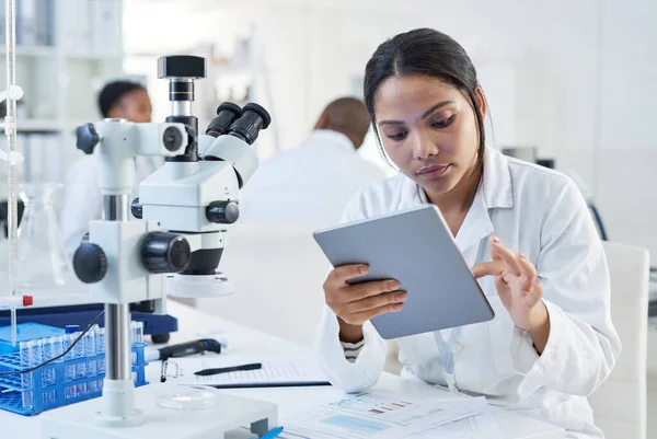 Making broader use of digital tools in the lab. a young scientist using a digital tablet in a lab