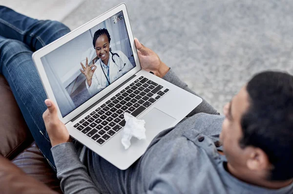 Its easier than ever to meet with your doctor online. a young doctor making an okay sign during a consultation with a patient on a laptop