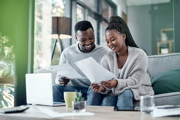 It takes two to do the financial tango. a young couple going through paperwork at home