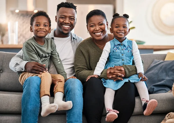 Home is the happiest place in the world. Portrait of a happy young family relaxing on the sofa at home