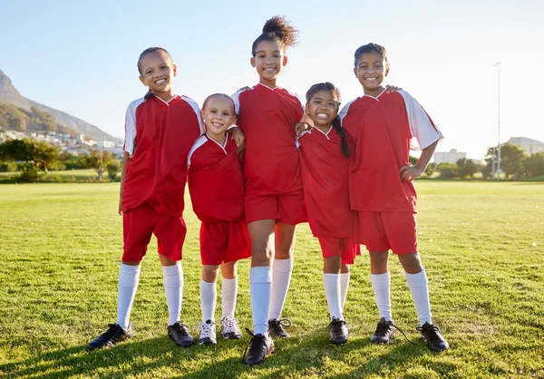 Sports, football and team portrait of children, friends group or athlete players happy before game. Teamwork, girls partnership and collaboration of youth kids on soccer field for training exercise.