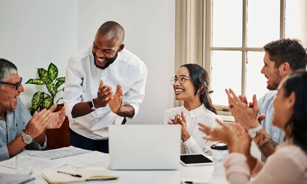 When work becomes a passion, youve already won. a group of businesspeople clapping while using a laptop during a meeting in a modern office