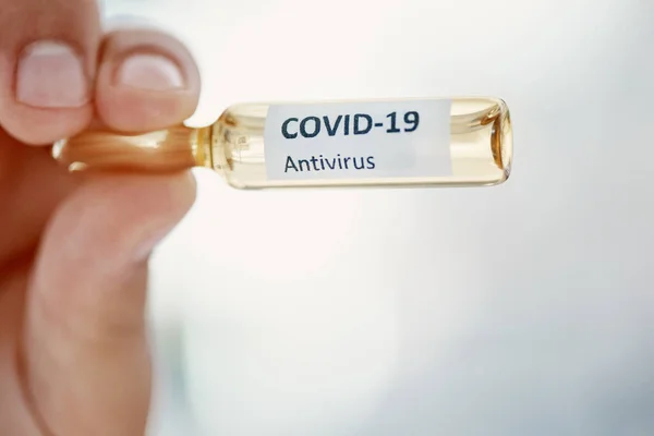 The official game changer. a scientist holding an ampoule with 2019-nCov on it
