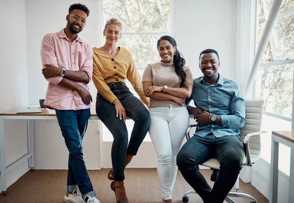Another day to rise in business. Cropped portrait of a diverse group businesspeople sitting together after a successful discussion in the office