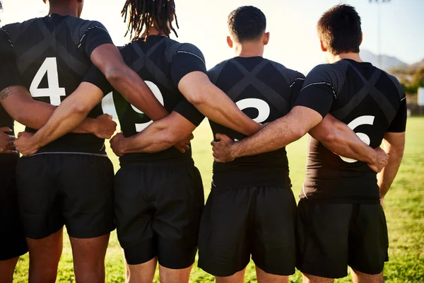 Nothing can tear us apart. a unrecognizable group of sportsmen standing together with their arms around each other before playing rugby