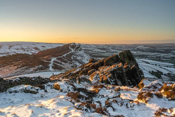 Hen Cloud, and The Roaches at sunrise during winter in the Peak District National Park.