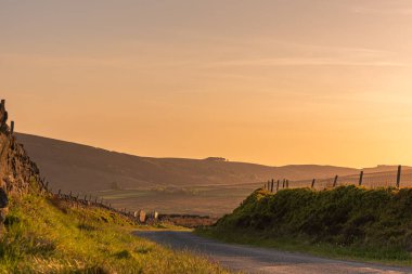 Gib Torr gün batımında Peak District Ulusal Parkı 'nda hamamböceklerine, Ranshaw Kayalıklarına ve Hen Bulutuna bakıyor..