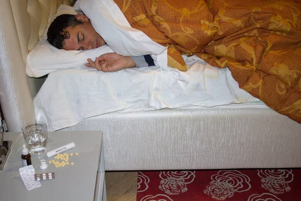 Image of a man sleeping in his bed after taking anxiolytics and antidepressants. Problem that plagues the new company