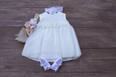 Picture of a little girl's dress with her accessories for her christening and party