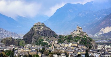 Panoramic view of historical Sion town with its two castles, Chateau de Tourbillon and Valere Basilica, spectacular set in the swiss Alps mountains valley, canton Valais, Switzerland