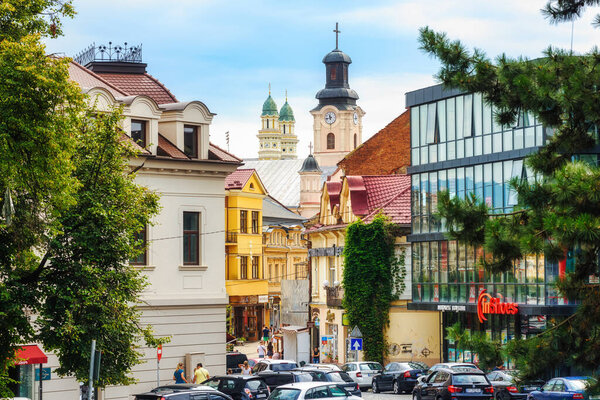 Uzhgorod, Ukraine - 27 July 2019: Modern and historical architecture in the Old town of Uzhgorod, Ukraine, view to the towers of the Roman catholic church and the Greek catholic Cathedral.