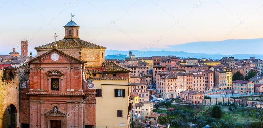 View over the historical San Giuseppe church and medieval Siena Old town to the valleys of Tuscany, Italy